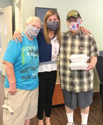 Clients receiveing their 50th anniversary brunch meals from the Council on Aging's Wilda Belisle