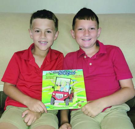 With a little transcribing help from their mom, Ayden and Colton Reiman wrote a book about a day in the life of living in their Kissimmee neighborhood. SUBMITTED PHOTO