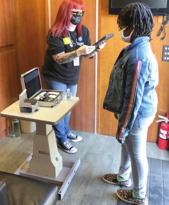 A Deerwood Elementary School student receives a free eyesight screening Friday during a OneSight event held ahead of Martin Luther King Day. PHOTO/TRANSITIONS OPTICAL