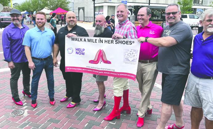 Local leaders donned high heels and other sensible ladies’ shoes for the annual Walk A Mile In Her Shoes, a Help Now of Osceola event designed to bring awareness to domestic violence and the proverbial miles victims walk in abusive relationships. PHOTO/DEBBIE DANIEL