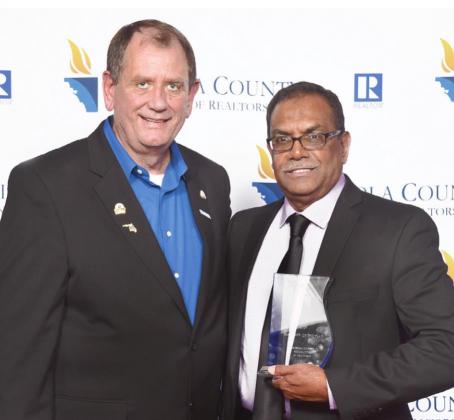 Imran Mohamed right receives OSCAR’s REALTOR® of the Year Award from President Donnie Martinez. SUBMITTED PHOTO