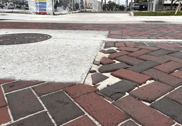 Despite a lengthy streetscaping project completed last year in downtown St. Cloud, newly-bricked streets feature gaps, dips, potholes and the sand base level rising to the surface in some vulnerable places on 10th Street. PHOTOS/THOMAS OUELLETTE