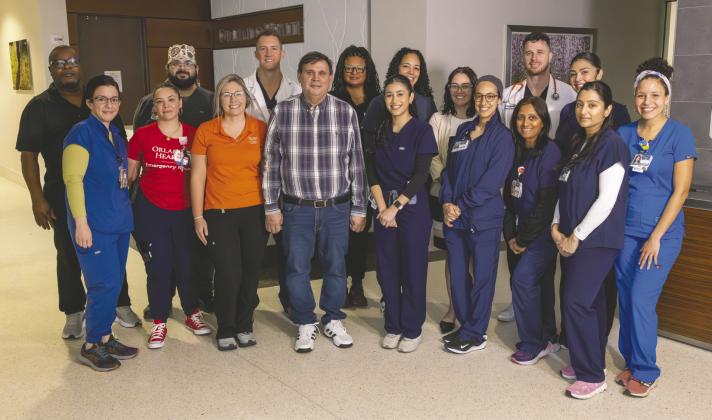 Thanks to quick work by the response care team at Orlando Health Emergency Room—Osceola, César Díaz Lira (fourth from left in front) was able to later reunite with that team that saved his life. (Photo/Orlando Health)
