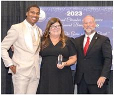 Osceola News-Gazette Owner Rochelle Stidham was honored by the St. Cloud Chamber of Commerce Saturday as its Business Champion of the Year. Right: Robb Larson of Osceola Heritage Park and Chamber President Dirk Webb pass the gavel to entrepreneur LaVell Monger. PHOTOS/CAPTURE WITH CASTO