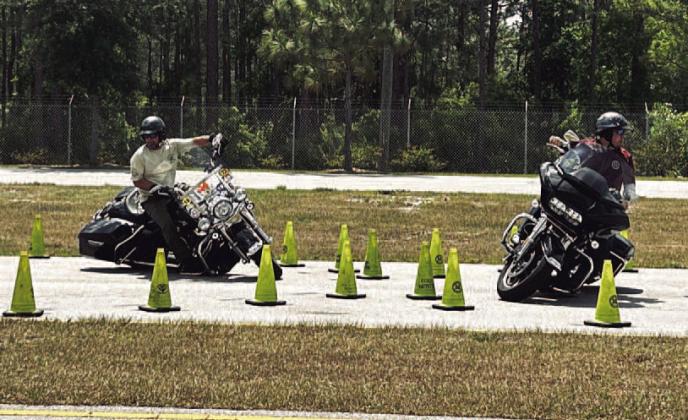 Participating officers showcasing a demonstration of the Operation Ride SMART course Sunday. PHOTO/MING HENRY