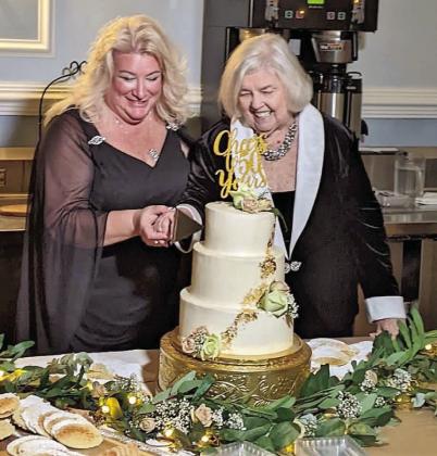 Osceola Council on Aging President/CEO Wendy Ford (left) and past President Beverly Hougland cut the anniversary cake at the Council’s 50th Anniversary Gala Feb. 4. PHOTO/COUNCIL ON AGING