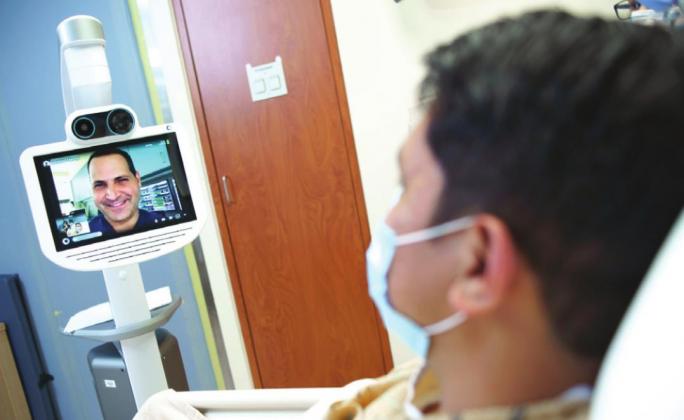 A physician uses Orlando Health St. Cloud Hospital’s new tele intensivist robot, nicknamed ‘Edward’, to provide care. SUBMITTED PHOTO’