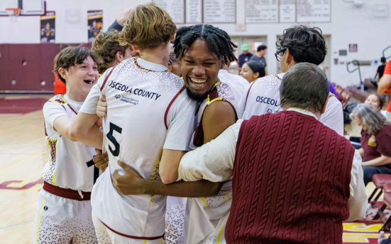 Partners Peyton Williams and Andrew Bradbury celebrate after helping their athletes again win the Florida Unified Basketball state championship (Photo/Taylor McFee)