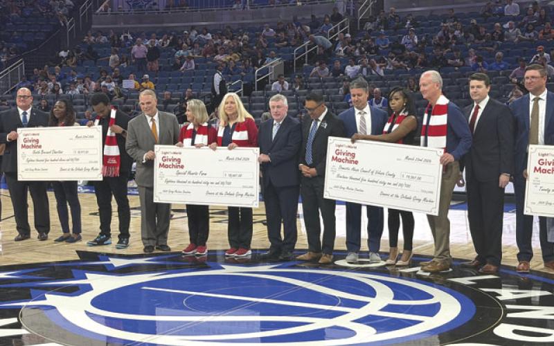 LDS Church leaders presented a check at Monday’s Orlando Magic game at the Kia Center. (Submitted Photo)