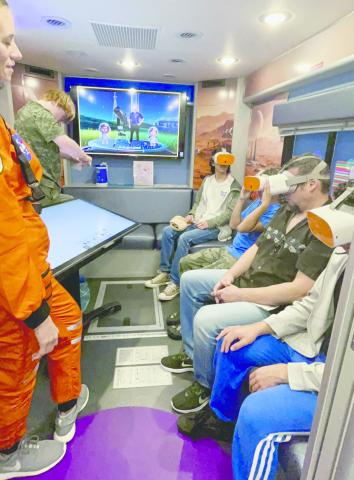 Visitors watch one of the rocket launches, and explore space through virtual reality, at the STEM Community Day Saturday at NeoCity. PHOTO/DEBBIE DANIEL