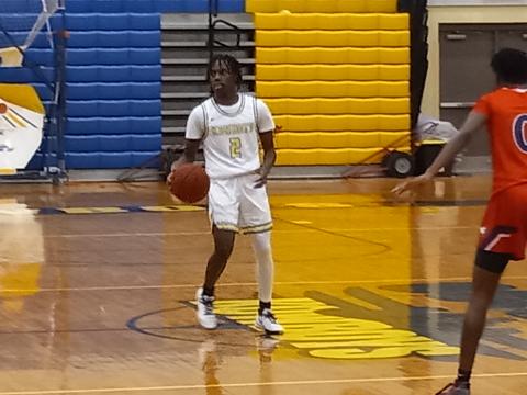 Chris Combs (2) brings the ball up court in the third quarter in Osceola's 55-25 OBC-clinching win Friday over Poinciana.  PHOTO/DAN PEARSON