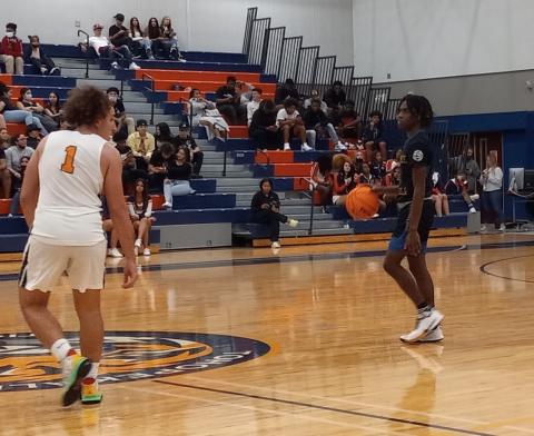 Chris Combs brings the ball up court against Tigers defender Josh Camejo.  Combs scored 11 second half points and 18 overall in leading the Kowboys to a 48-37 win Friday. PHOTO/J. DANIEL PEARSON