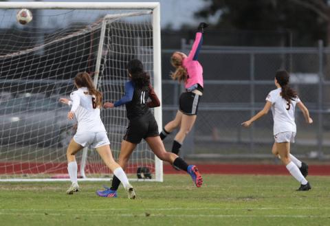 St. Cloud fires a shot past Harmony goalie Olivia Godfrey in Friday's District 6A-7 semifinal match. PHOTO/ROB HERBERT