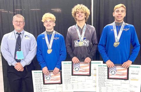 It never gets old: Osceola wrestlers (from left) Anderson Heap (126 pounds), Gunner Holland (160) and Cooper Haase (138), pictured with Coach Jim Bird, gave the Kowboys state champs for the 16th straight season. PHOTO/OSCEOLA H.S.