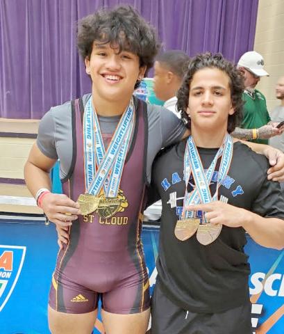 St. Cloud’s Julian Sykes (left) and Harmony’s Isaac Balado (right) with their hardware from the Class 3A state weightlifting meet, are the county's Boys Weighlifters of the Year. PHOTO/CORY AUN, ST. CLOUD H.S.