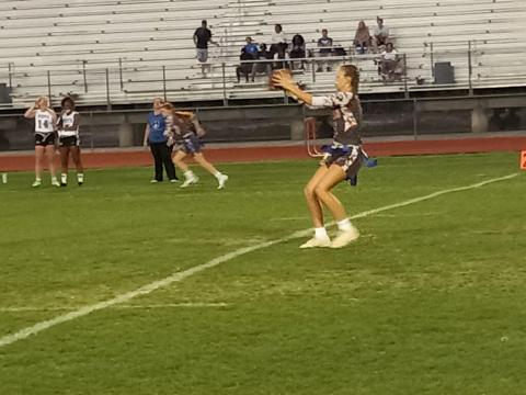Harmony QB Martha Edwards takes a snap from center against Park Vista. PHOTO/DAN PEARSON