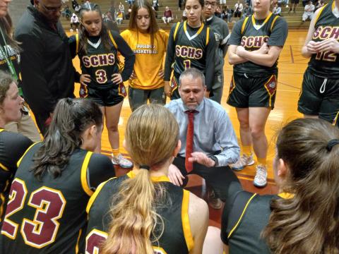 St. Cloud head coach Chad Ansbaugh talks to his team during a timeout last season.  The Lady Bulldogs, who went 20-9 last season and advanced to the regional finals, will join county opponent Liberty and play in Class 6A, District 7 this season.  (Photo by J. Daniel Pearson)