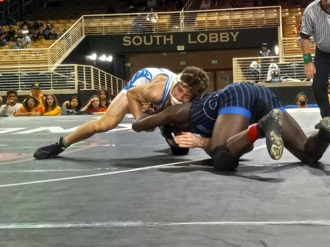 Anderson Heap (white singlet) maneuvers around Cass, Ga.'s Tyler McKnight during the 145-lb. final of the 10th Annual Knockout Christmas Classic at Silver Spurs Arena. PHOTO/J. DANIEL PEARSON