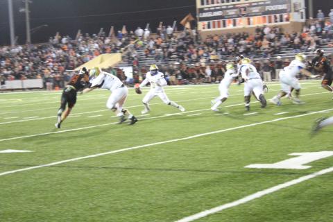 Osceola quarterback David Buggs rolls out early in the second quarter, and would hit Bo Mascoe on this play for a touchdown pass that gave the Kowboys an early lead Friday over Lakeland in the Class 4S state semifinal. PHOTO/KEN JACKSON