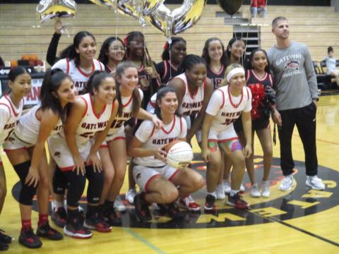 Gateway junior Malayna Stevenson (center kneeling) was presented a game ball Thursday to commemorate her 1000th career point with the Panthers. PHOTO/J. DANIEL PEARSON