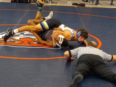 :  Osceola’s Gunner Holland (top) gets ready to turn St. Cloud’s Jose Martinez in the 170-lb. semifinals of the Orange Belt Conference wrestling tournament.  Holland went on to win the match and his weight class for the third year in a row. PHOTO/J. DANIEL PEARSON