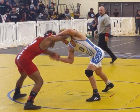Anderson Heap (in blue and white at last week's regional meet) will wrestle for a 145-pound Class 3A FHSAA state title Saturday sometime after 4 p.m. at the Silver Spurs Arena. FILE PHOTO