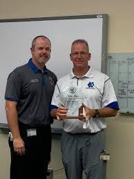Osceola High baseball coach Scott Birchler, accepting a Coach of the Year award from Osceola Athletic Director Ryan Adams, announced his coaching retirement Tuesday night. PHOTO/RICK TRIBIT