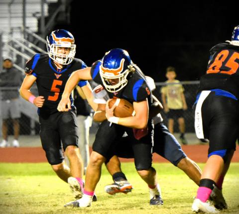 Harmony quarterback Kal Amen (6, with ball) and Jeremy Hilliard (5) made big plays on offense and accounted for all three Longhorn touchdowns in a surprising 23-14 win over Tohopekaliga. PHOTO/KATIE WILLIAMS 