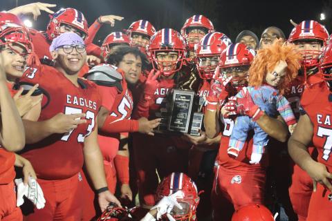 Poinciana players pose with the Battle of the Boulevard trophy after Friday's 35-8 victory. PHOTO/KEN JACKSON