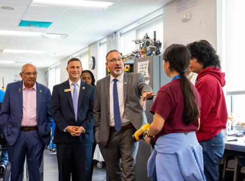 From left, state Sen. Victor Torres, U.S. Rep. Darren Soto and U.S. Secretary of Education Miguel Cardona meet with NeoCity Academy students Thursday on a tour of the Kissimmee school. PHOTO/TAYLOR MCFEE