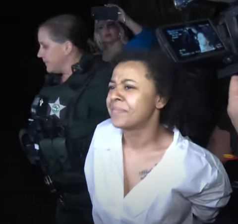 Kelsey Glover is led to a squad car to take her to the Osceola County Jail Wednesday. She's been charged with aggravated assault and battery following her teen daughter's death. OSCEOLA COUNTY SHERIFFS OFFICE