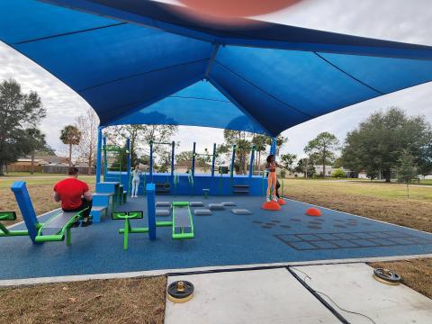 Osceola County officials cut the ribbon Wednesday on a new public fitness pad – the first of its kind in the county – at 65th Infantry Park in Buenaventura Lakes. PHOTO/KEN JACKSON