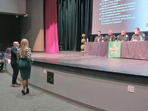 PHOTO/LARRY GRIFFIN Jorge Figueroa, president of the Puerto Rican Chamber of Commerce of Central Florida, asks an Osceola County Sheriff’s Office panel a question at Thursday’s immigration town hall meeting at Gateway High.