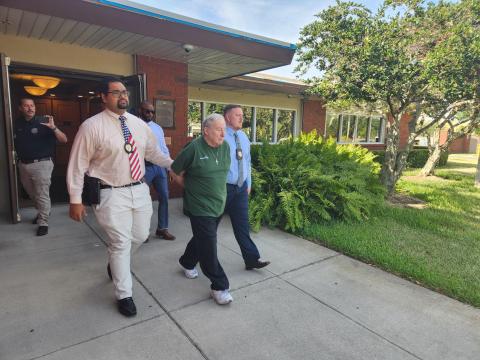 St. Cloud Police detectives lead Gene Stuller away to the Osceola County Jail after his arrest in connection to a 1991 murder case. PHOTO/KEN JACKSON 
