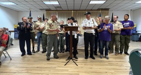 Osceola County Veterans Council First Vice Commander, Army veteran Helen Dottie Addams, presents a $500 scholarship and certificate of appreciation to Kissimmee Scouting America Troop 662 for their veteran-related community activity throughout the year.  (Photo/Terry Lloyd)