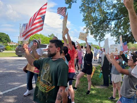 Protestors came out by the dozens to protest against the policies of President Donald Trump at Saturday's "No Kings" protest along John Young Parkway in Kissimmee. (Photo/Larry Griffin)