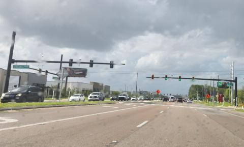 A new traffic light, serving a new shopping area, is in service on North Orange Blossom Trail at Country Road. The light at Osceola Parkway is immediately north of that. (Photo/Ken Jackson)