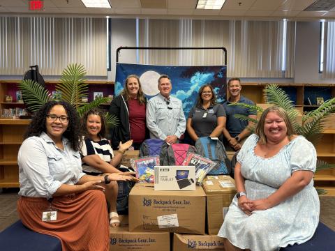 School supplies arrive at Reedy Creek Elementary School, alma mater of Commissioner Brandon Arrington (center), during his Back-To-School drive. Pictured with school officials is Reedy Creek Principal Katie Adams (left of Arrington).