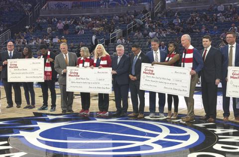 LDS Church leaders presented a check at Monday’s Orlando Magic game at the Kia Center. (Submitted Photo)