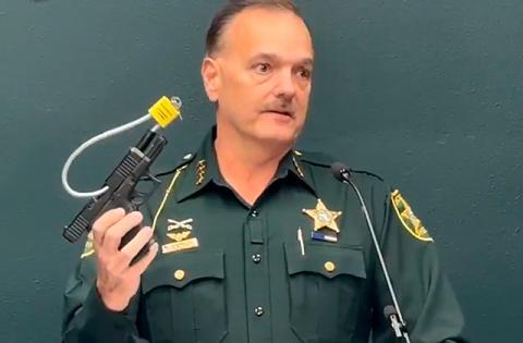 Osceola County Sheriff Chris Blackmon showed off a gun lock, like the ones it will give away at a May 1 event. (Photo/Osceola Sheriff's Office)