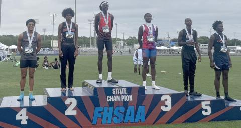 Gateway’s Maxwell Garcon (center) soared past 50 feet in the triple jump and won the Class 3A championship Friday at the Class 3A state meet at the University of North Florida. (Photo/Matt Distler)