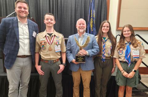 2026 Golden Eagle Award recipient Brian Wetzel, president of Orlando Health St. Cloud Hospital, with present Hans Steinbrenner of the Osceola Magic and Eagle Scouts Alex Heppermann, Delaney Townes and Caroline Krywonos. (Photo/Ken Jackson)