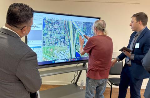Turnpike staff discuss impacts on U.S. 192 with a commercial property owner in the project area. (Photo/Terry Lloyd)