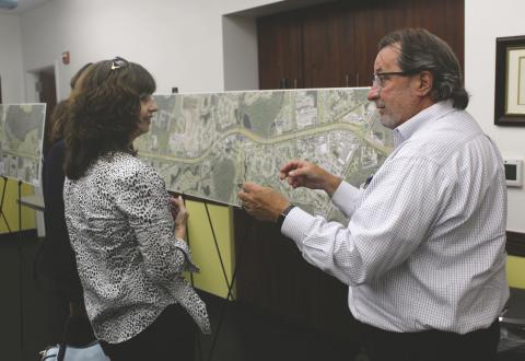Poinciana resident Wendy Farrell (left) discusses some of the proposed Southport Connector and Cypress Parkway plans with CFX Program Manager Ralph Bove at Monday’s stakeholders meeting. PHOTO/KEN JACKSON