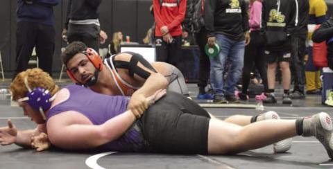 Harmony’s Nelson Toro (top) works over Palatka’s Mikade Harvey in the 285-pound finals of The Hammer Tournament in Jacksonville. Toro won the match, 11-1. PHOTO/HARMONY HIGH SCHOOL