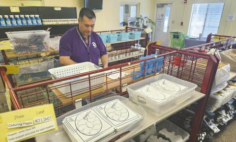 Celebration High School teacher Richard Holley-Byrd picks up supplies in his July run at A Gift For Teaching, which makes it possible for students to get the things they need to success, without teachers needing to reach into their pockets. PHOTO/KEN JACKSON