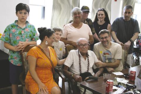 Family gathers to celebrate U.S. Navy veteran Robert Belisario, Sr.’s 100th birthday. Standing from left, Luke Belisario, Liam Wahl, Bev Tautalatasi, Robert Belisario, Jr., Jodi Wahl, Jason Van Patten. Seated from left, Karen Herro-Backe, Robert Belisario, Sr., Jon Belisario. (Photo/Michelle Kostuch)