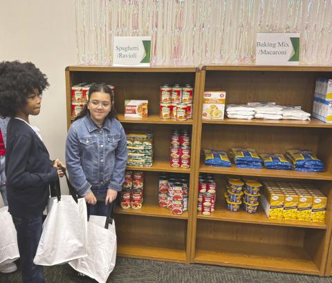 Second Harvest Food Bank of Central Florida teamed up with the Poinsette Foundation to open Benny’s Bodega, a food pantry at Kissimmee Elementary School last week. PHOTO/DAVID CHIVERS