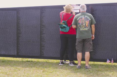 Lisa Raso of Winter Springs makes a pencil rubbing of her fallen cousin’s name, Army PFC Edward Grandpre. PHOTO/TERRY LLOYD