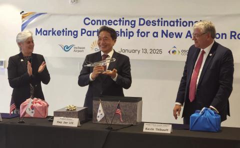 Osceola County Commissiner Cheryl Grieb and Greater Orlando Aviation Authority CEO Kevin Thibault present Incheon International Airport Corporation President and CEO Hag-Jae Lee a gift at Monday’s announcement of a planned direct flight connection from Seoul, Korea to Orlando and NeoCity’s doorstep. PHOTO/KEN JACKSON